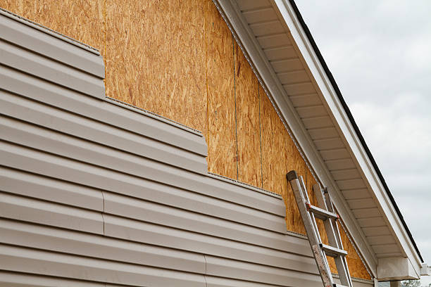 Professional Storm Damage Siding Repair technician working in Malverne, NY